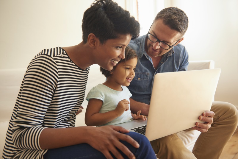 photo of family looking at a laptop