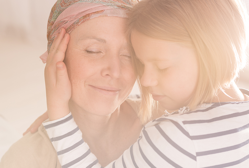 photo of child holding woman's face